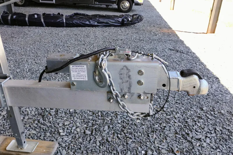Slide: The Image of Trailer hitch with safety chain on gravel, Clearwater 2500 Center Console, 2024 model. - 11