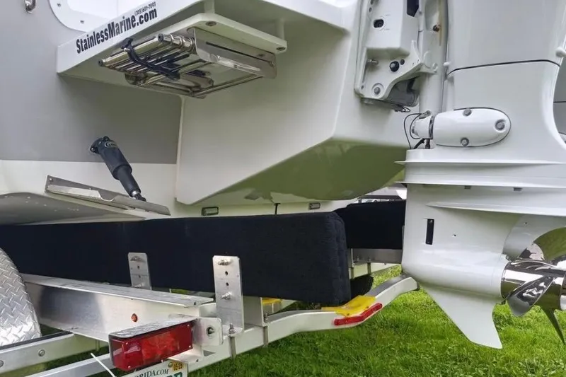 Slide: The Image of 2024 Clearwater 2500 boat on trailer, featuring stainless steel components and outboard motor. - 7