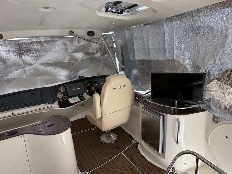 Slide: The Image of Interior of a 2012 Meridian 441 Sedan yacht with helm and TV. - 15