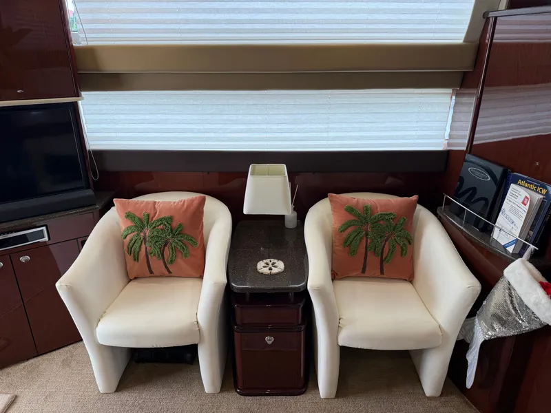 Slide: The Image of Interior of a 2012 Meridian 441 Sedan yacht with white chairs and palm pillows. - 33