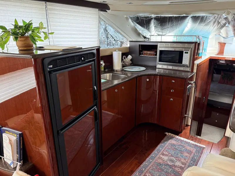 Slide: The Image of Interior of Meridian 441 Sedan yacht, kitchen with microwave and fridge. - 34