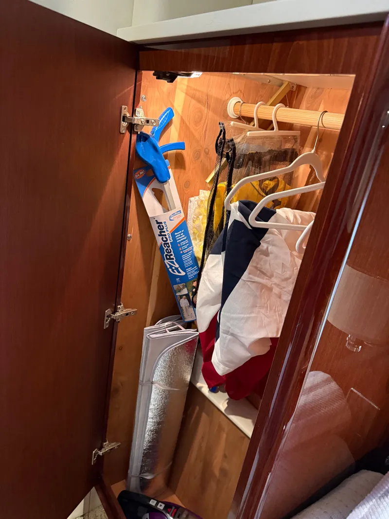 Slide: The Image of Interior of a 2012 Meridian 441 Sedan cabinet with clothes and accessories. - 45