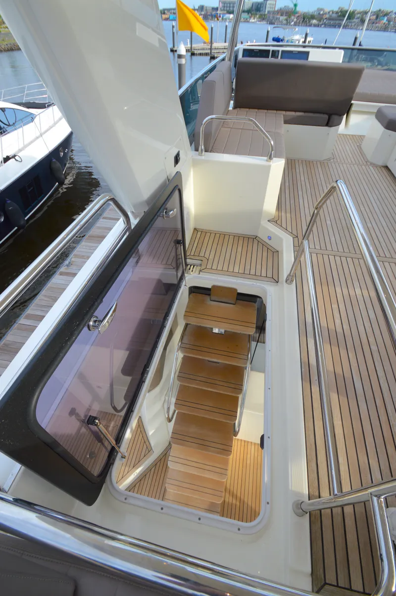 Slide: The Image of Prestige 630 Yacht, 2017, featuring open staircase and teak deck. - 19