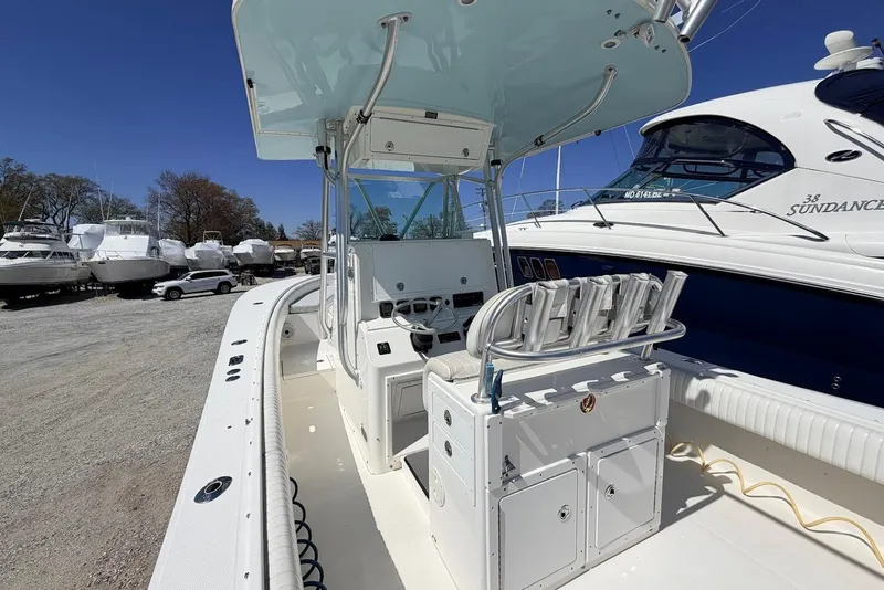 Slide: The Image of 2006 Regulator 29 Forward Seating boat with center console and seating, docked outdoors. - 15