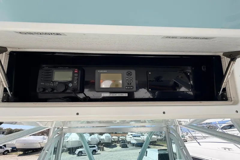 Slide: The Image of 2006 Regulator 29 Forward Seating boat dashboard with navigation and communication equipment. - 16