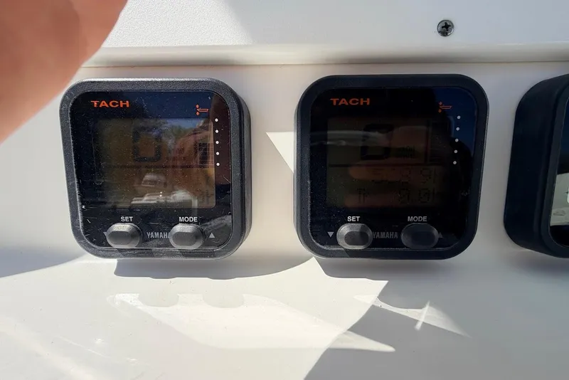 Slide: The Image of Yamaha tachometers on a 2006 Regulator 29 Forward Seating boat dashboard. - 17