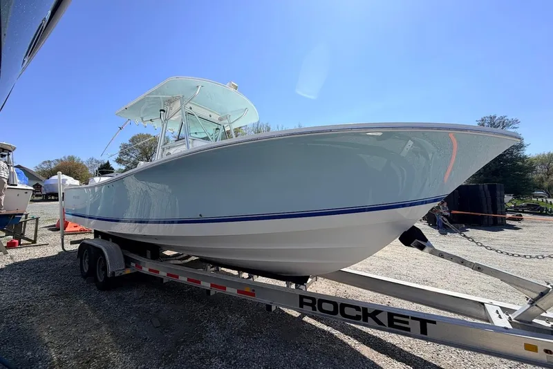 Slide: The Image of 2006 Regulator 29 Forward Seating boat on trailer under clear blue sky. - 19