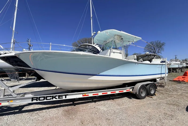 Slide: The Image of 2006 Regulator 29 Forward Seating boat on a trailer under clear blue sky. - 20