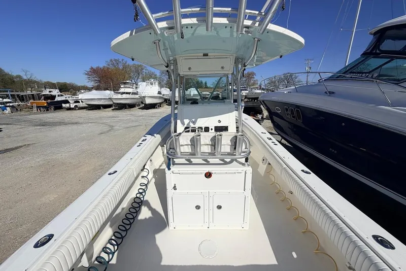 Slide: The Image of 2006 Regulator 29 Forward Seating boat with center console, docked among other vessels. - 3