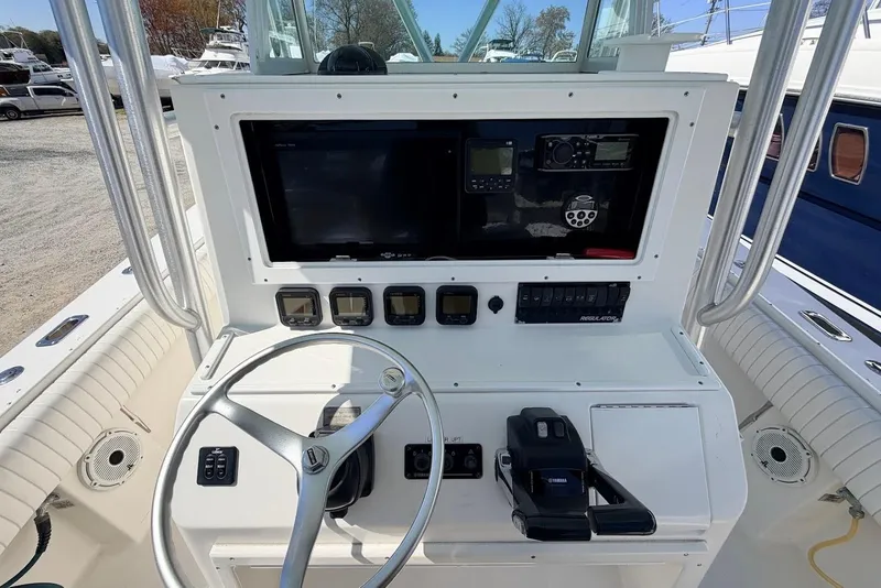 Slide: The Image of 2006 Regulator 29 Forward Seating boat dashboard with steering wheel and navigation controls. - 5