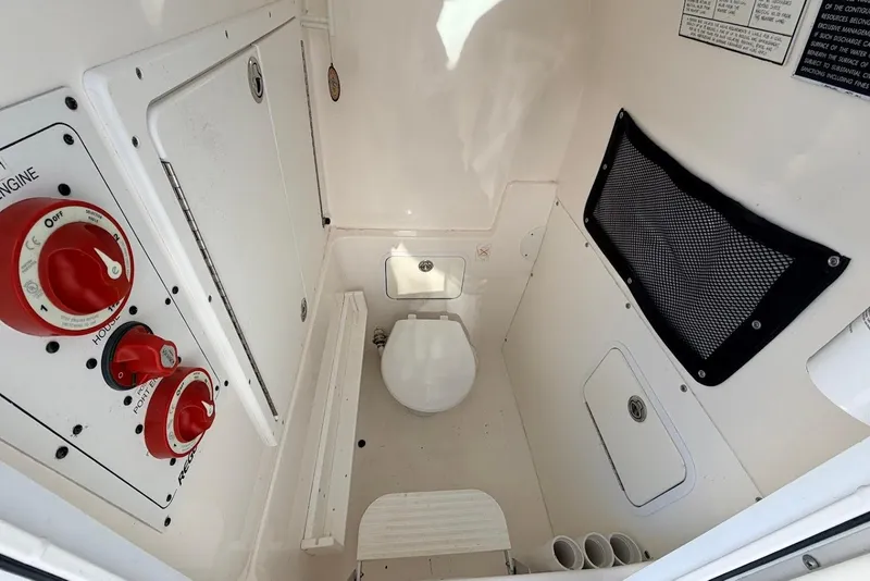 Slide: The Image of 2006 Regulator 29 Forward Seating boat interior with toilet and control panel. - 7