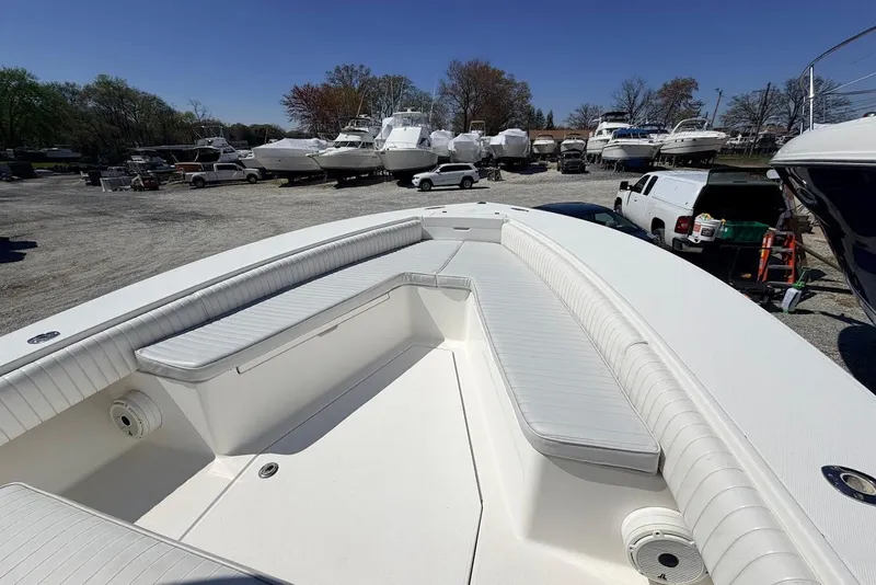Slide: The Image of 2006 Regulator 29 Forward Seating boat with spacious deck and seating in a marina. - 8