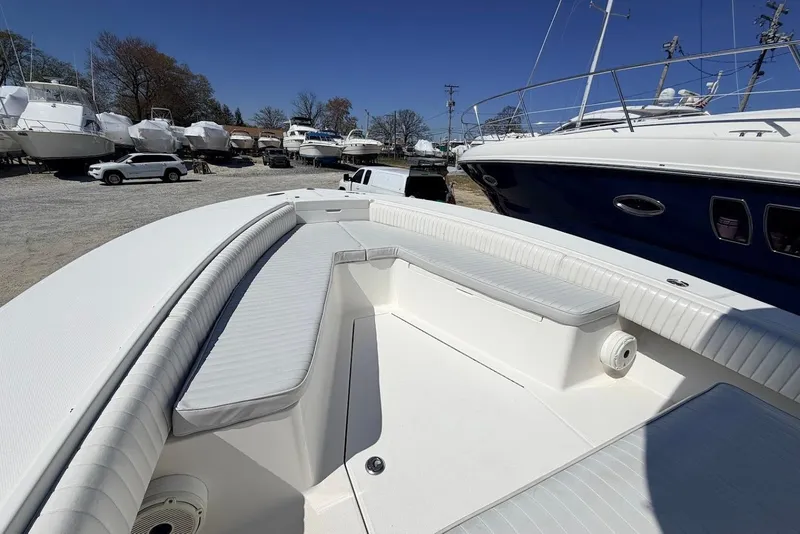 Slide: The Image of 2006 Regulator 29 Forward Seating boat with spacious deck in a marina setting. - 9