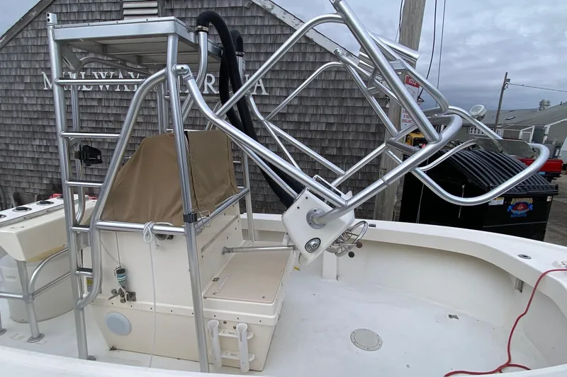 Slide: The Image of 2000 Parker 1801 Center Console boat with metal framework and covered seating area. - 4