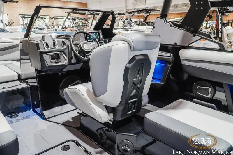 Slide: The Image of 2026 Axis A245 boat interior with modern dashboard and seating at Lake Norman Marina. - 13
