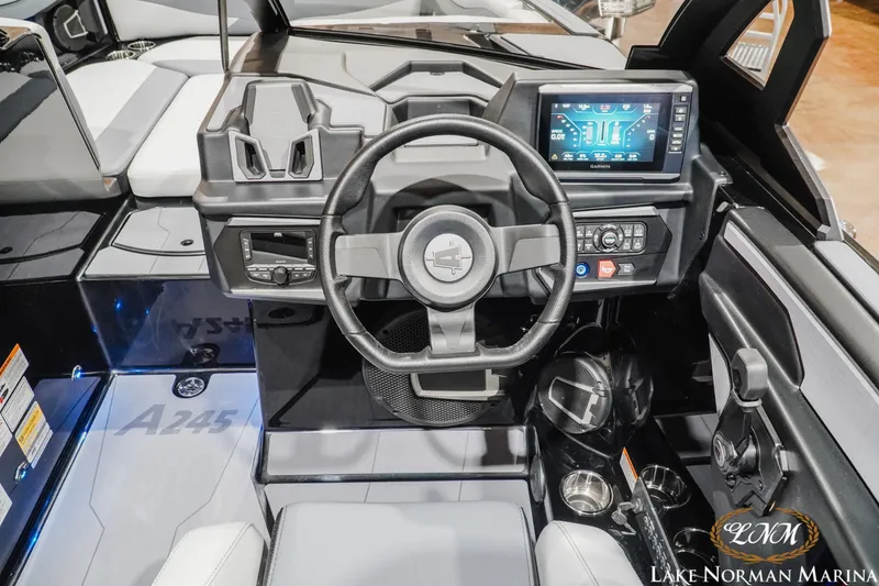 Slide: The Image of 2026 Axis A245 boat dashboard with steering wheel, touchscreen display, and control panel. - 14