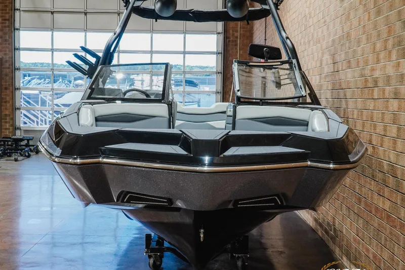 Slide: The Image of 2026 Axis A245 boat in showroom, sleek design, black exterior, modern features. - 4