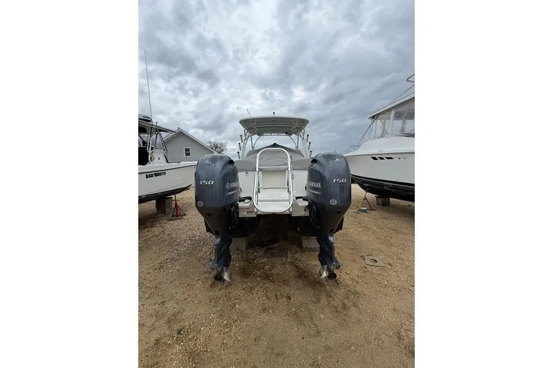 Slide: The Image of 2019 World Cat 255 DC boat with twin Yamaha 150 engines on a cloudy day. - 5