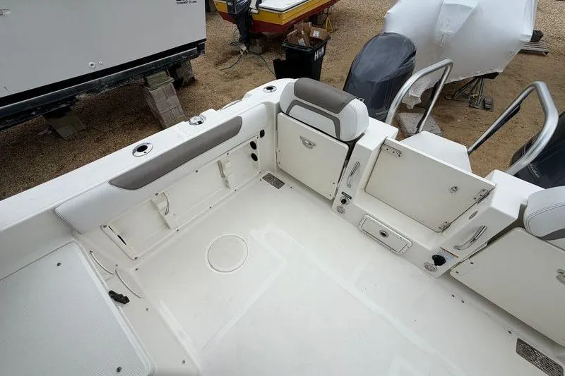 Slide: The Image of 2019 World Cat 255 DC boat interior with seating and storage compartments. - 7