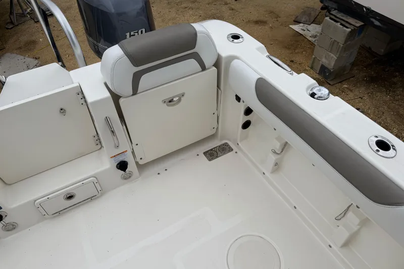 Slide: The Image of 2019 World Cat 255 DC boat interior with seating and storage compartments. - 8