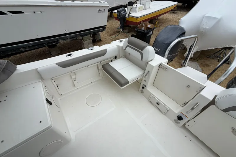Slide: The Image of 2019 World Cat 255 DC boat interior with seating and storage compartments. - 9