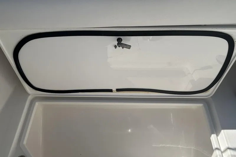 Slide: The Image of Storage compartment on a 2018 Albemarle 29 Express boat, featuring a secure latch. - 11