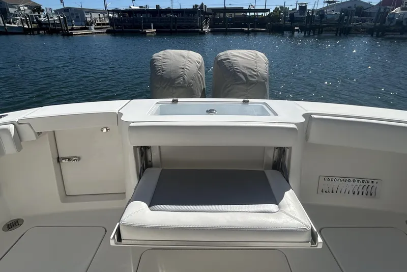 Slide: The Image of 2018 Albemarle 29 Express boat stern with seating and covered engines by the dock. - 13