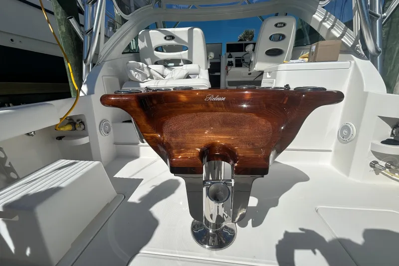 Slide: The Image of 2018 Albemarle 29 Express boat interior with polished wood helm and seating area. - 17