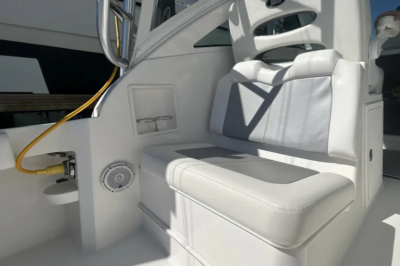Slide: The Image of 2018 Albemarle 29 Express boat interior with cushioned seating and speaker. - 20