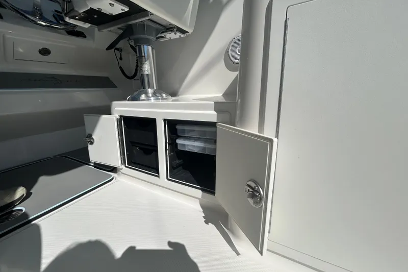 Slide: The Image of 2018 Albemarle 29 Express boat interior storage compartments with open doors. - 25