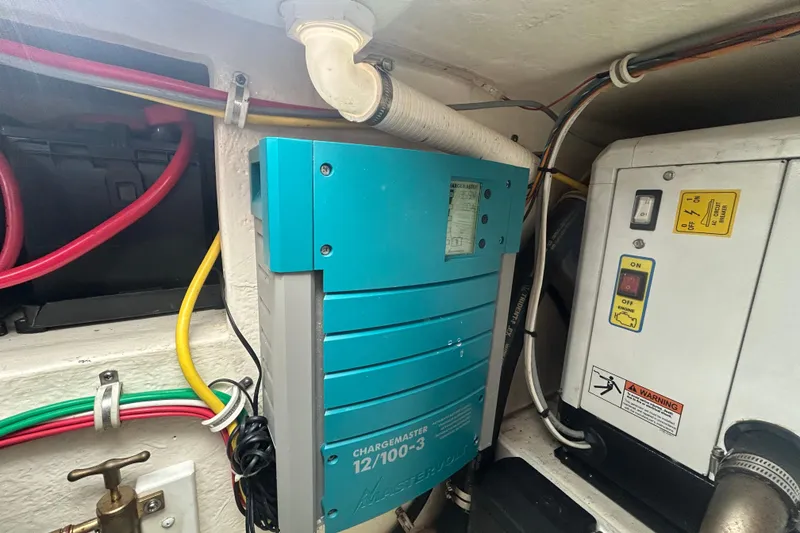 Slide: The Image of Electrical components inside a 2018 Albemarle 29 Express boat, featuring wiring and a charger. - 29