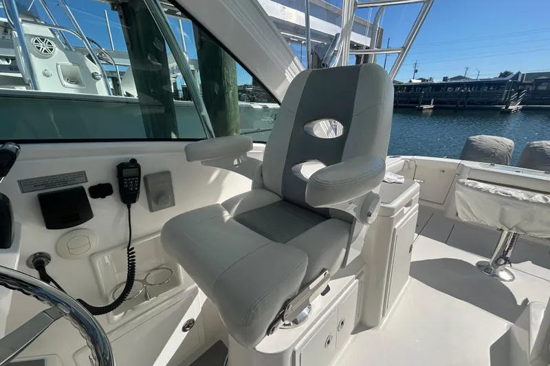 Slide: The Image of Captain's chair on 2018 Albemarle 29 Express boat, docked by the water. - 32