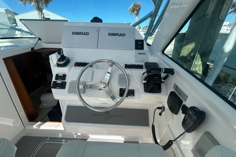 Slide: The Image of Helm of 2018 Albemarle 29 Express boat with Simrad electronics and steering wheel. - 33