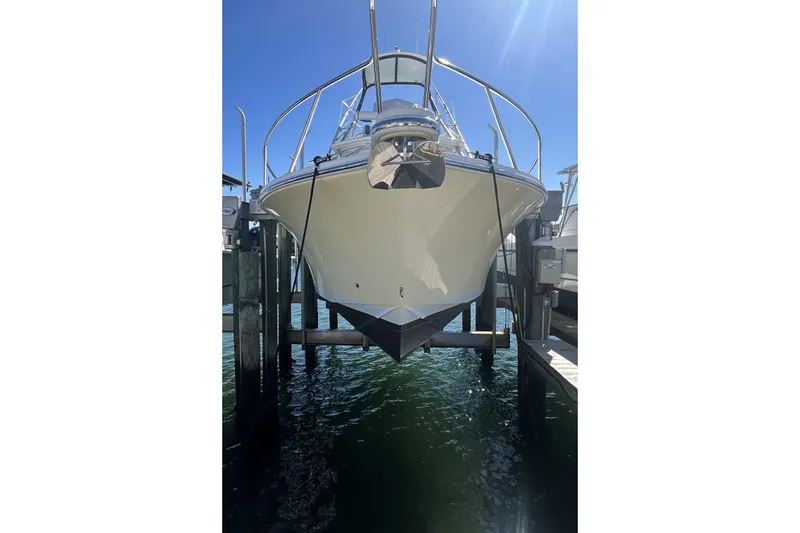 Slide: The Image of 2018 Albemarle 29 Express boat docked on lift under clear blue sky. - 4