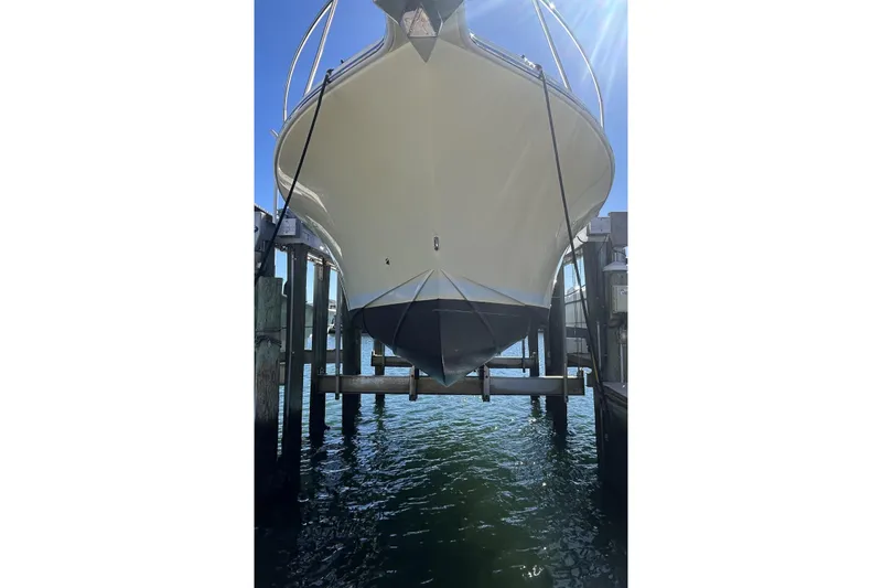Slide: The Image of 2018 Albemarle 29 Express boat on lift, viewed from below, with clear blue sky. - 5