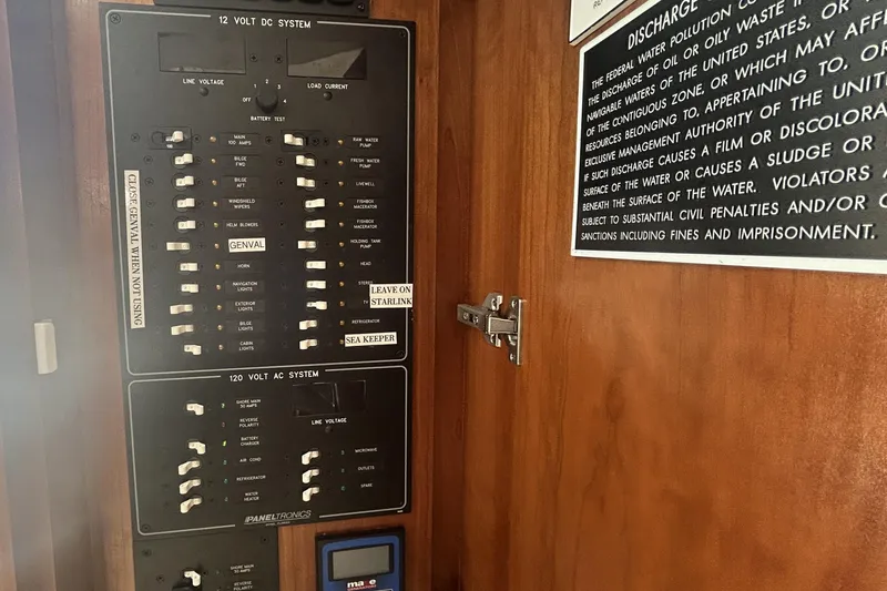 Slide: The Image of Electrical panel on 2018 Albemarle 29 Express boat with discharge warning sign. - 50