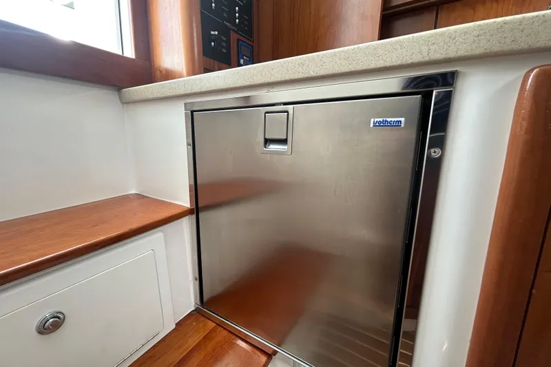 Slide: The Image of Stainless steel fridge in 2018 Albemarle 29 Express boat interior. - 54