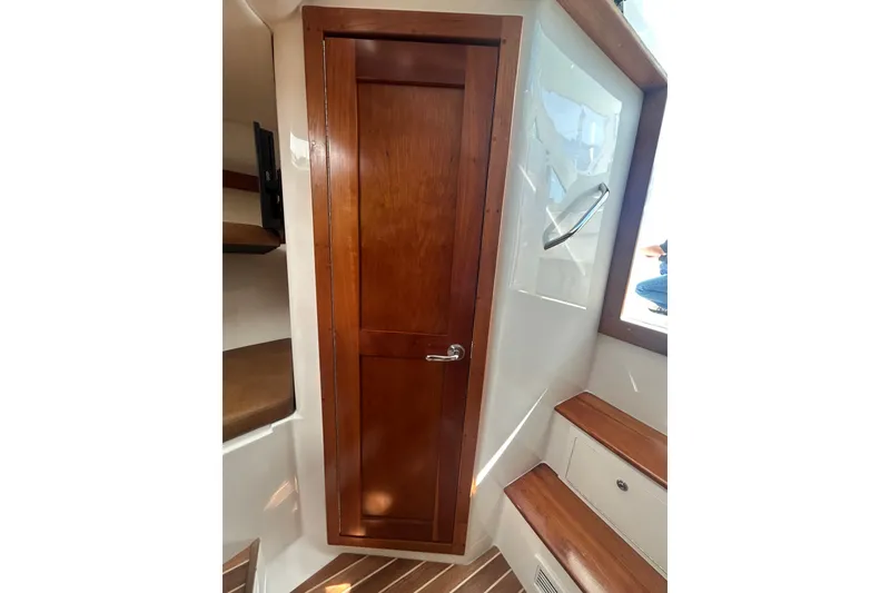 Slide: The Image of 2018 Albemarle 29 Express cabin interior with wooden door and steps. - 58
