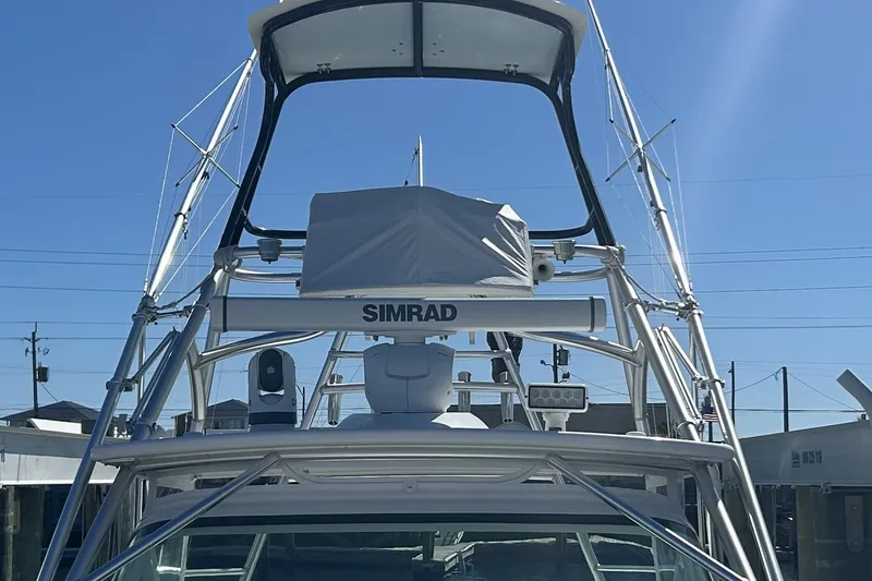 Slide: The Image of 2018 Albemarle 29 Express boat with Simrad equipment, docked under clear blue sky. - 6
