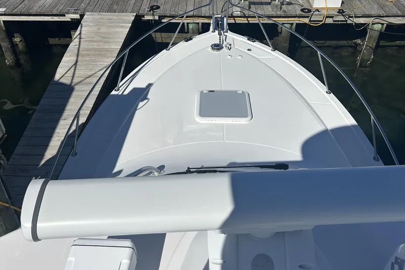 Slide: The Image of 2018 Albemarle 29 Express boat docked, showcasing sleek bow design and deck features. - 61