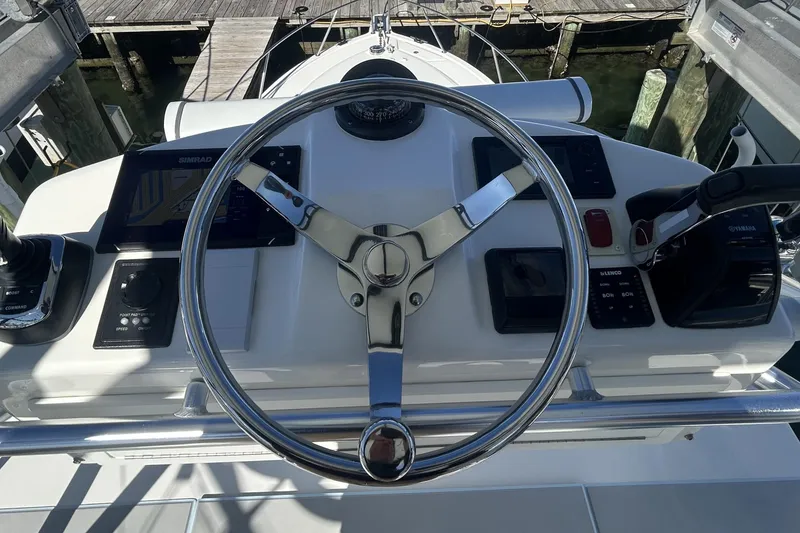 Slide: The Image of Helm of 2018 Albemarle 29 Express boat with steering wheel and navigation controls. - 63