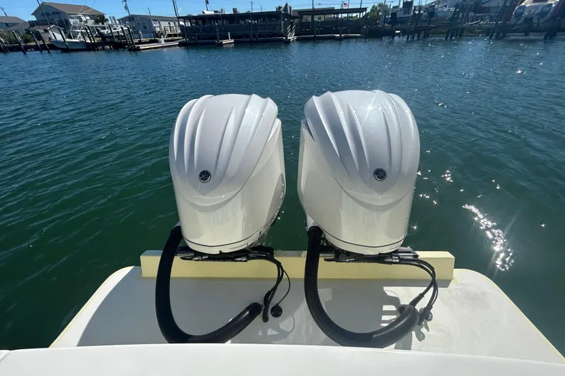 Slide: The Image of Twin outboard engines on a 2018 Albemarle 29 Express boat, docked by the water. - 7