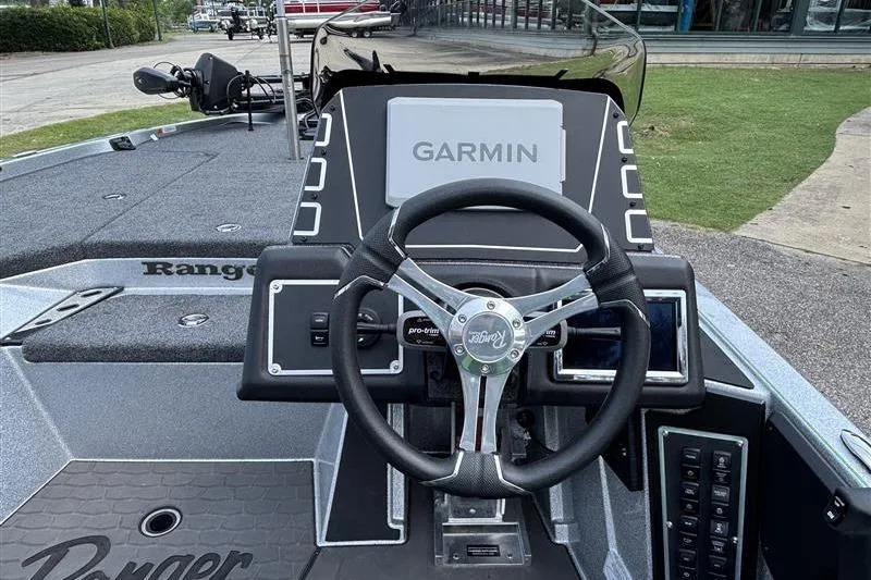 Slide: The Image of 2026 Ranger Z519R Cup-Equipped boat dashboard with Garmin navigation system and steering wheel. - 14