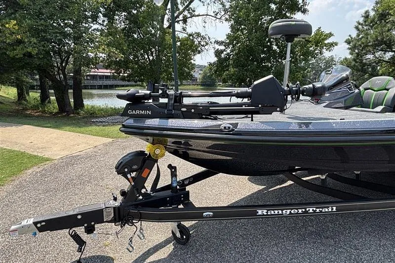 Slide: The Image of 2026 Ranger Z519R Cup-Equipped boat on trailer, featuring Garmin equipment, near a scenic lake. - 1