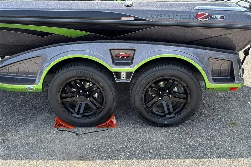 Slide: The Image of 2026 Ranger Z519R Cup-Equipped boat trailer with dual black wheels and green accents. - 8