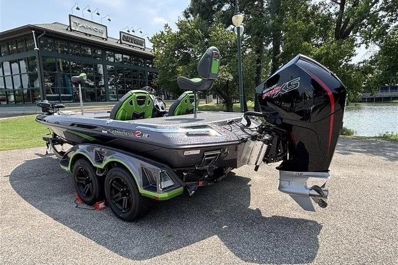 Slide: The Image of 2026 Ranger Z519R Cup-Equipped boat with powerful engine, parked near a lake. - 5