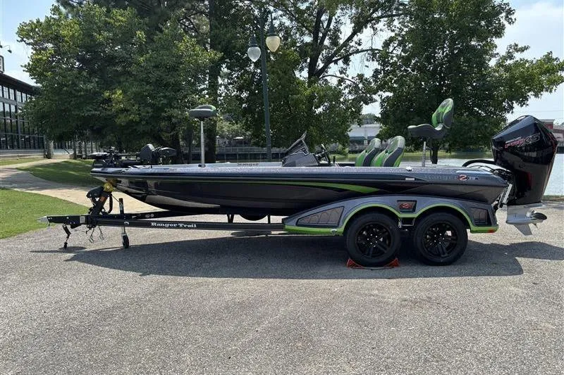 The Image of 2026 Ranger Z519R Cup-Equipped boat on trailer, parked outdoors near trees. - 0