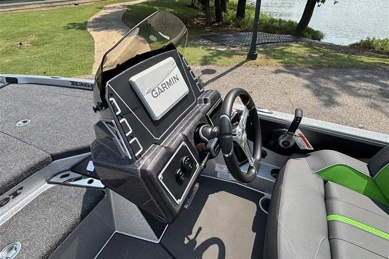Slide: The Image of 2026 Ranger Z519R Cup-Equipped boat dashboard with Garmin display and steering wheel. - 13