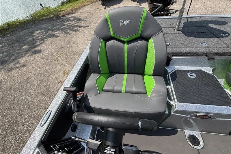 Slide: The Image of 2026 Ranger Z519R Cup-Equipped boat seat with green accents, parked by a lake. - 19