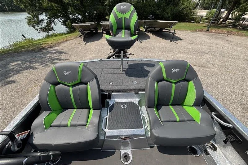 Slide: The Image of 2026 Ranger Z519R Cup-Equipped boat seats with green accents, parked near a lake. - 21